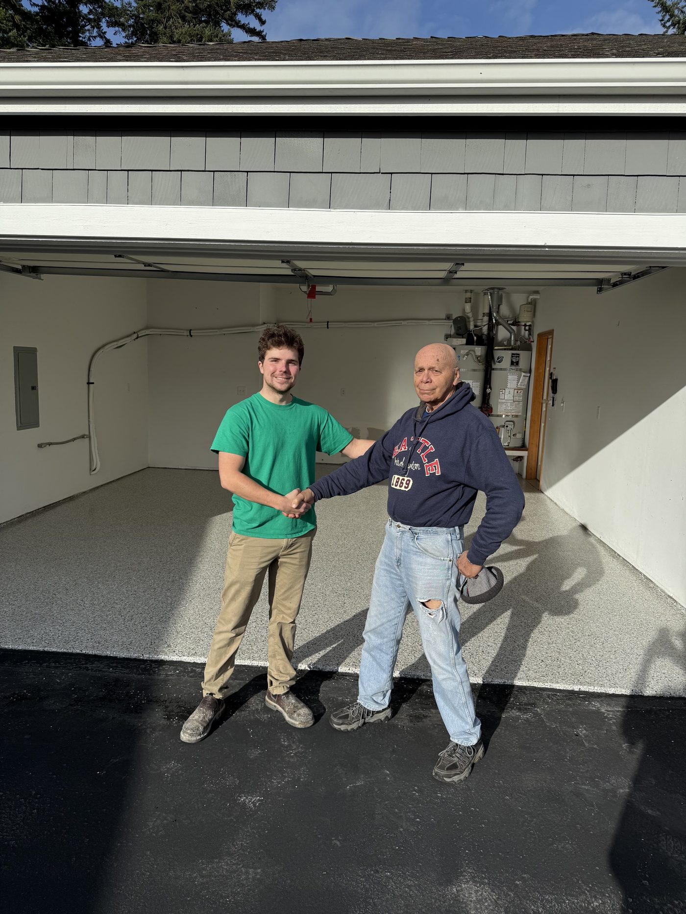 Owners with customer in finished flake garage