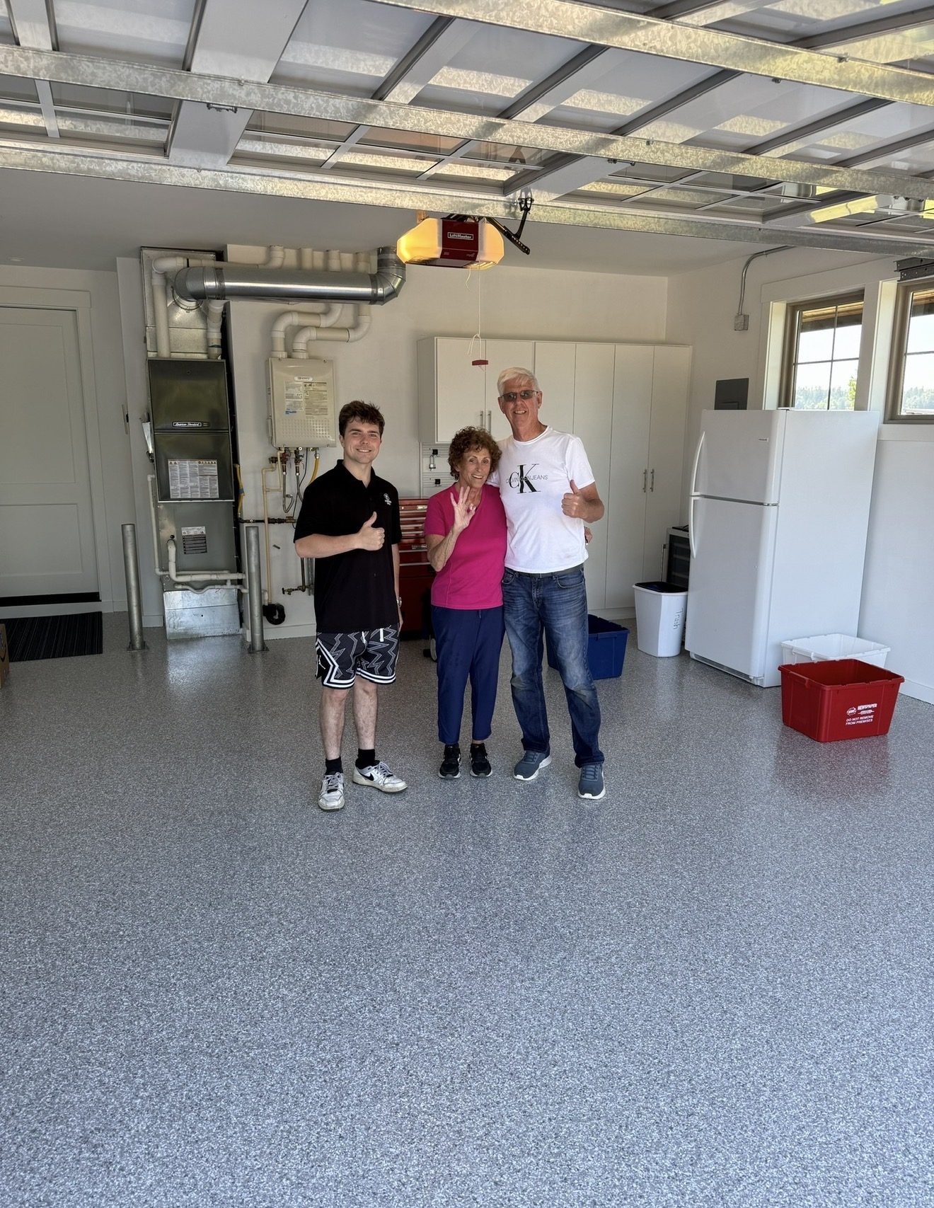 Happy clients with crew on new flake garage floor
