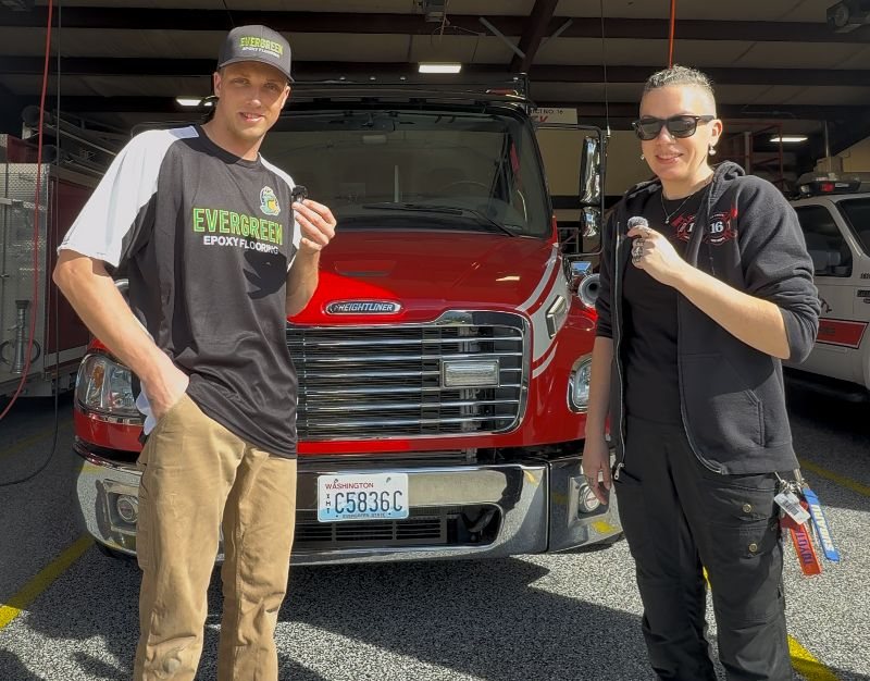 Owner with firefighter on new station floor