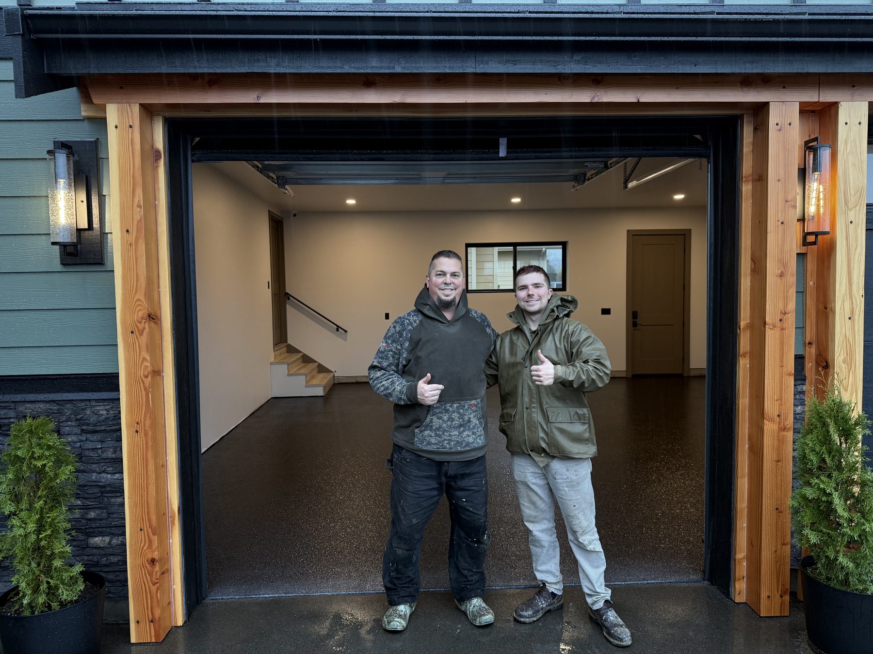 Owner with Kevin of Semia Renovations in front of a finished flake garage floor